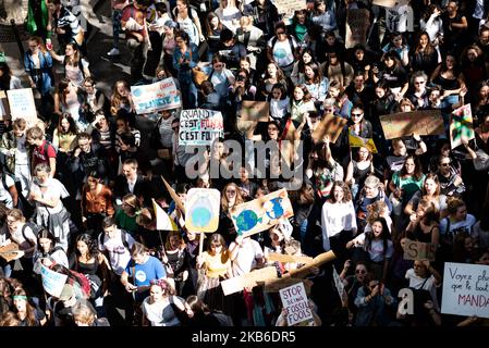 Top view of the procession of young demonstrators holding signs for the climate emergency on which slogans such as 'When it's melted it's over' or 'Stop being fossil fools' can be read, this Friday, September 20, 2019 in Paris as part of the global strike day for the climate and the movement initiated by Greta Thunberg 'Friday for Future' and organized by the Youth for Climate movement. In Paris, about 9400 young people gathered at Place de la Nation to go to the Bercy garden with numerous signs and slogans reminding the governments of the climate emergency and denouncing their inaction. (Phot Stock Photo