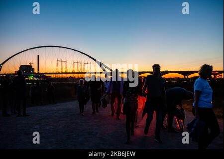 This year, 75 years after Operation Market Garden, the Dutch city of Nijmegen celebrate 75 Years of freedom, in Nijmegen, Netherlands, on September 21, 2019. During this Sunset March, they gave special attention to the 48 allied soldiers who died 75 years ago during the heroic crossing of the Waal river. 48 light towers turned on and at the same time, 48 light rays illuminated the sky. This tribute to them was supported by an opera spectacle from the water. The Sunset March ends at the Waalcrossing monument, where people could leave flowers. (Photo by Romy Arroyo Fernandez/NurPhoto) Stock Photo