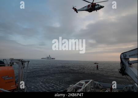 Crewmembers assigned to USCGC Hamilton (WMSL 753) are hoisted down onto the Swedish Coast Guard vessel Amfitrite during a search and rescue exercise in the Baltic Sea, Oct. 31, 2022. Hamilton is on a scheduled deployment in the U.S. Naval Forces Europe area of operations, employed by U.S. Sixth Fleet to defend U.S., allied and partner interests. (U.S. Coast Guard photo by Petty Officer 3rd Class Alejandro Rivera) Stock Photo