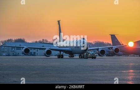 Airmen from the 191st Aircraft Maintenance Squadron at Selfridge Air National Guard Base, Michigan, tow a KC-135 Stratotanker early morning to the west side of the base using an MB-2 tow tractor Nov. 2, 2022. The tow tractor is a work-horse used to transport heavy aircraft across the flightline without powering on the aircraft, conserving energy resources. (U.S. Air National Guard photo by Terry L. Atwell) Stock Photo