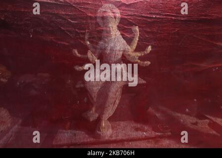 An idol of Hindu Goddess Durga, is seen through a cloth inside a workshop in Mumbai, India on 26 September 2019. Durga Puja is celebrated to honour the victory of goddess Durga over the demon king Mahishasura. (Photo by Himanshu Bhatt/NurPhoto) Stock Photo