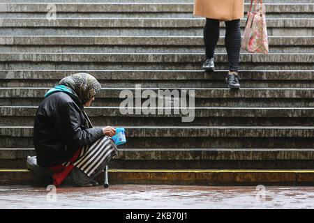 An elderly woman begs for mercy at the street downtown Kyiv, Ukraine, September 26, 2019. The mission of the International Monetary Fund (IMF) leaves Kyiv without reason to recommend that the IMF board of directors conclude a new lending program with Ukraine after working for two weeks in the country. (Photo by Sergii Kharchenko/NurPhoto) Stock Photo