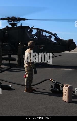 U.S. Army Soldiers assigned to 2nd Battalion, 25th Aviation Regiment, 25th Combat Aviation Brigade, 25th Infantry Division conduct routine checks and refuel AH-64 Apache helicopters as part of Joint Pacific Multinational Readiness Center rotation 23-01 in Hawaii, Nov. 1, 2022. JPMRC 23-01 is a regional combat training center rotation that builds combat readiness in America's Pacific Division and is a key way the Army forces engage in a joint environment with regional allies and partners. (U.S. Army photo by Sgt. Daymeon Evans) Stock Photo