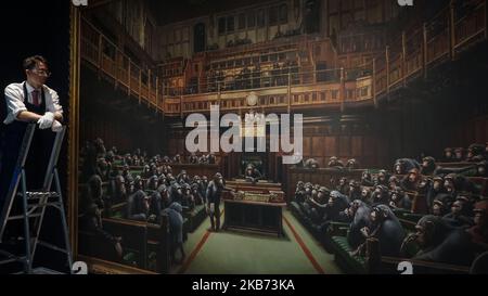 Gallery workers pose with the Banksy painting 'Devolved Parliament' at Sotheby's on September 27, 2019 in London, England. Photo call for Banksy's Devolved Parliament painting ahead of it being offered at auction by Sotheby's. The artwork showing the House of Commons full of chimpanzees is expected to fetch GBP1.5 to GBP2 million. (Photo by Giannis Alexopoulos/NurPhoto) Stock Photo