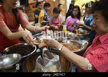 People shop for vegetarian food at market in Chinatown, Bangkok,Thailand. 28 September 2019. (Photo by Anusak Laowilas/NurPhoto) Stock Photo