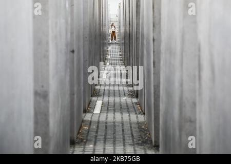 A woman walks around the Memorial To The Murdered Jews Of Europe in Berlin, Germany on 25 September, 2019. The monument also known as the Holocaust Memorial was designed by architect Peter Eisenman and engineer Buro Happold. It consists of 2,711 concrete slabs arranged in a grid pattern. (Photo by Beata Zawrzel/NurPhoto) Stock Photo