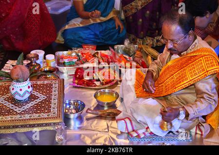 Bengali Hindu priest performs special prayers honouring the Goddess Durga during the Durga Puja festival at a pandal (temporary temple) in Mississauga, Ontario, Canada, on September 28, 2019. Hundreds of Bengalis (who have now migrated to Canada from Kolkata, India) attended the celebration. Durga Puja is one of the largest Hindu festivals that involves worship of Goddess Durga symbolizing the power and triumph of good over evil in Hindu mythology. (Photo by Creative Touch Imaging Ltd./NurPhoto) Stock Photo