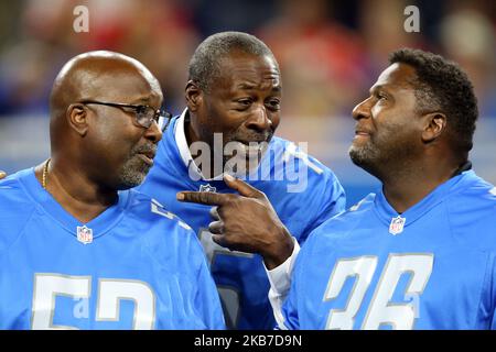 Former Detroit Lions center Kevin Glover (53), former Detroit Lions  offensive tackle Lomas Brown (75), and former Detroit Lions safety Bennie  Blades (36) joke around during a ceremony honoring the Lions All Time Team  during halftime of an NFL football