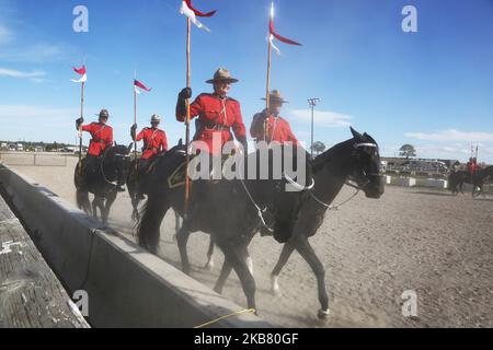 Members of the RCMP (Royal Canadian Mounted Police) perform on horseback during the RCMP Musical Ride in Markham, Ontario, Canada, on October 05, 2019. The Musical Ride of the Royal Canadian Mounted Police is an event showcasing the equestrian skills performed by 32 cavalry who are regular members of the police force. (Photo by Creative Touch Imaging Ltd./NurPhoto) Stock Photo