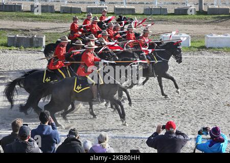 Members of the RCMP (Royal Canadian Mounted Police) perform on horseback during the RCMP Musical Ride in Markham, Ontario, Canada, on October 05, 2019. The Musical Ride of the Royal Canadian Mounted Police is an event showcasing the equestrian skills performed by 32 cavalry who are regular members of the police force. (Photo by Creative Touch Imaging Ltd./NurPhoto) Stock Photo