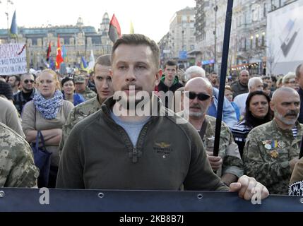 Andriy Biletsky ,the leader of political party National Corps, takes part at a march against the so called 'Steinmeier formula', as they mark the 77th anniversary of the founding of the Ukrainian Insurgent Army and in central Kiev, Ukraine, on 14 October, 2019. Thousands activists of different nationalist parties and movements marched in the center of Ukrainian capital celebrating the founding of the Ukrainian Insurgent Army and Defender of Ukraine Day. The Ukrainian Insurgent Army or UPA fought for Ukrainian independence against the Red Army and the Nazi wermacht during the WWII. On 1 October Stock Photo