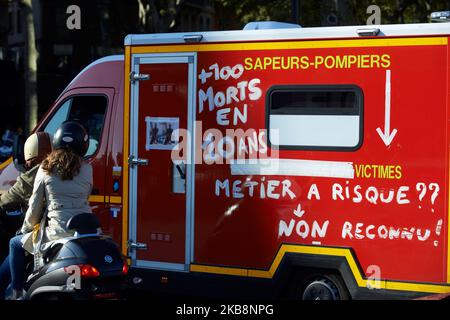 A firefighters'truck has painted on it 'More than 100 dead in 10yo, it's a risky job' as French firefighters are on strike since june 26th. They aren't enough to confront the french population rise. For the Act 49 of their protest, Yellow Vests protesters wanted to pay tribute to firefighters and medics (street medics) and against French President Macron, his government, its policies. They demand fiscal and social justice, more ecology and the RIC (Citizens Initiated Referendum). After only a dozen of minutes, Gendarmerie Mobile (military) and CRS (riot police) began to use tear gas canisters  Stock Photo