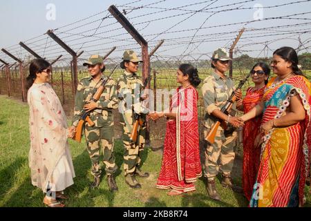 Border Security Forces (BSF ) jawans and Samaryan jointly celebrate Pre Diwali, lit up border with diyas and candles and 1100 diya's,Distribute Sweets etc at India - Bangladesh International border , 72 Indian ,House Wife and children's and BSF Senior officers part in the program at Petrapole-Benapole Border on October 20,2019 in West Bengal,India. Hindu festival 'Diwali', or festival of Lights, which falls on October 27 this year. (Photo by Debajyoti Chakraborty/NurPhoto) Stock Photo