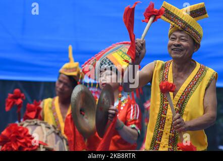 Members of a local music band from Zhuang ethnic group dressed in a traditional Zhuang dresses perform at finish line of the fourth stage, Nanning to Nongla stage, of the 3rd edition of the Cycling Tour de Guangxi 2019. On Sunday, October 20, 2019, in Nongla Scenic Area, Mashan County, Guangxi Region, China. (Photo by Artur Widak/NurPhoto) Stock Photo