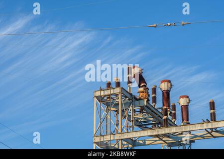Section of a power station with a storm damaged component on a wispy cloud background Stock Photo