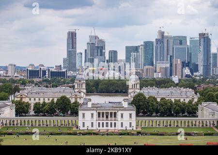 Canary Wharf as seen in epic cloudy panoramic view, Maritime Museum, Old Royal Naval College and London Skyline from Greenwich Park during the day in London England. Canary Wharf is a secondary central financial and business district CBD of London, with many banks located there, skyscraper and many under construction with modern architecture high with glass facade buildings. (Photo by Nicolas Economou/NurPhoto) Stock Photo