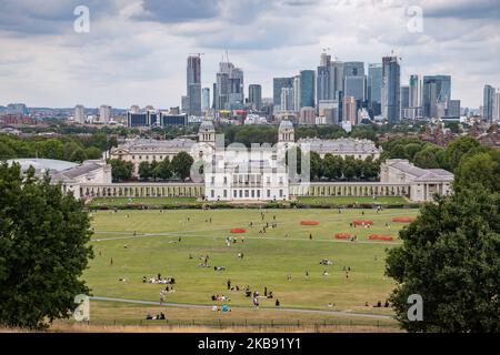 Canary Wharf as seen in epic cloudy panoramic view, Maritime Museum, Old Royal Naval College and London Skyline from Greenwich Park during the day in London England. Canary Wharf is a secondary central financial and business district CBD of London, with many banks located there, skyscraper and many under construction with modern architecture high with glass facade buildings. (Photo by Nicolas Economou/NurPhoto) Stock Photo