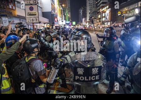 A Riot Police Officer is seen holding up a bottle of Pepper Spray during an Anti-Government Protest in Yuen Long district in Hong Kong, China, October 26, 2019, Pro-Democracy Protesters have a been taking to the streets for months in protest. (Photo by Vernon Yuen/NurPhoto) Stock Photo
