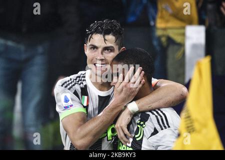 Juventus forward Cristiano Ronaldo (7) celebrates with Juventus forward Douglas Costa (11) after scoring his goal to make it 2-1 during the Serie A football match n.10 JUVENTUS - GENOA on October 30, 2019 at the Allianz Stadium in Turin, Piedmont, Italy. Final result: Juventus-Genoa 2-1. (Photo by Matteo Bottanelli/NurPhoto) Stock Photo