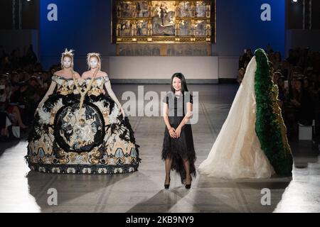 Chinese fashion designer Guo Pei acknowledges the audience at the end of her first ever runway show in the UK, staged to celebrate the 20th anniversary of the V&A's Fashion in Motion series on 01 November, 2019 in London, England. (Photo by WIktor Szymanowicz/NurPhoto) Stock Photo