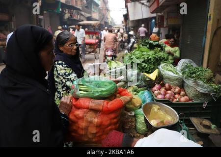 Women purchase vegetables from a vendor near Jama Masjid in Old Delhi India on 03 November 2019 (Photo by Nasir Kachroo/NurPhoto) Stock Photo