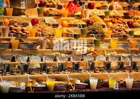 Mountains of sweets and vegetarian snacks are displayed in front of the deities at the BAPS Shri Swaminarayan Temple during the Annakut Darshan (also known as Annakut Utsav and Govardhan Puja) which takes place on fifth and final day of the festival of Diwali, which marks the start of the Hindu New Year, in Toronto, Ontario, Canada on October 28, 2019. Annakut which means a 'large mountain of food' which is offered to God as a sign of devotion. BAPS (Bochasanwasi Shri Akshar Purushottam Swaminarayan Sanstha) is a sect of Hinduism's Diksha Vidhi and their temples, though dedicated to many Hindu Stock Photo