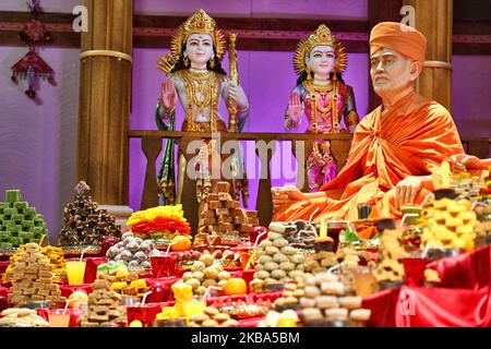 Mountains of sweets and vegetarian snacks are displayed in front of the deities at the BAPS Shri Swaminarayan Temple during the Annakut Darshan (also known as Annakut Utsav and Govardhan Puja) which takes place on fifth and final day of the festival of Diwali, which marks the start of the Hindu New Year, in Toronto, Ontario, Canada on October 28, 2019. Annakut which means a 'large mountain of food' which is offered to God as a sign of devotion. BAPS (Bochasanwasi Shri Akshar Purushottam Swaminarayan Sanstha) is a sect of Hinduism's Diksha Vidhi and their temples, though dedicated to many Hindu Stock Photo