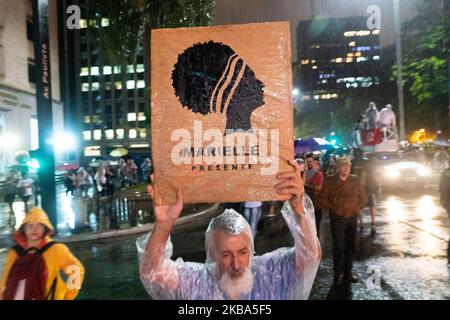 A demonstrator carries a sign that reads 'Marielle present' during protest against the current Brazilian President Jair Messias Bolsonaro and a tribute to human rights activist and councilwoman Marielle Franco on the 600th day of her murder in Paulista Avenue, São Paulo, Brazil November 5, 2019. (Footage by Felipe Beltrame/NurPhoto) Stock Photo