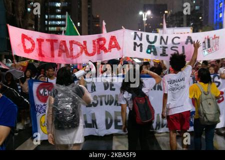 Demonstrators carrying a sign that reads 'Dictatorship neve again' during protest against the current Brazilian President Jair Messias Bolsonaro and a tribute to human rights activist and councilwoman Marielle Franco on the 600th day of her murder in Paulista Avenue, São Paulo, Brazil November 5, 2019. (Footage by Felipe Beltrame/NurPhoto) Stock Photo