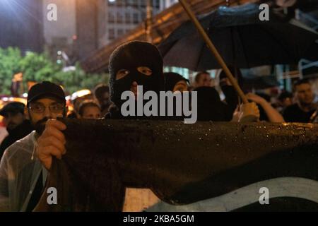 An anarchist demonstrator during a protest against the current Brazilian President Jair Messias Bolsonaro and a tribute to human rights activist and councilwoman Marielle Franco on the 600th day of her murder in São Paulo, Brazil November 5, 2019 (Footage by Felipe Beltrame/NurPhoto) Stock Photo