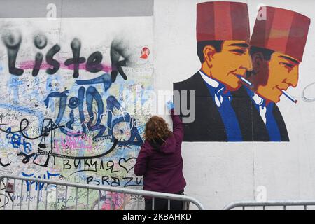 a street artist starts a new mural on a still-standing section of the former Berlin Wall called the East Side Gallery, of the Berlin Wall. On Saturday, November 9, 2019, in Berlin, Germany. (Photo by Artur Widak/NurPhoto) Stock Photo