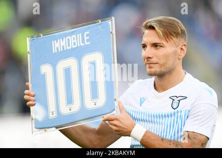 Ciro Immobile of SS Lazio poses with the award received for 100