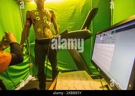 A man undergoing an Exercise Stress Test walking and running on a treadmill while hooked up to equipment that monitors his heart rate, breathing, blood pressure, electrical activity and his level of tiredness during My Sweetheart, a Free Hearts Checks event at Mal Ciputra in Semarang, Central Java, Indonesia on November 19, 2019. The event that was initiated by Mal Ciputra and Telogorejo Hospital was attended by at least 100 men. (Photo by WF Sihardian/NurPhoto) Stock Photo