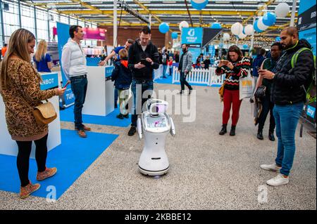 A robot is playing music and dancing surrounded by some audience, during the Bright Day Festival in Amsterdam, on November 23rd, 2019. (Photo by Romy Arroyo Fernandez/NurPhoto) Stock Photo