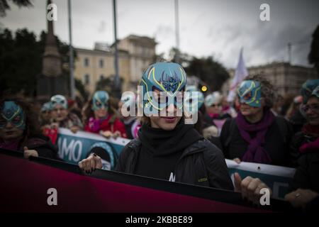 Women wear masks from the 'Lucha y Siesta' Women's Home project (Casa Delle Donne) for women victims of violence, during a protest march organized by the 'Non Una di Meno' (Not One Less !) movement in Rome, on November 23, 2019. Thousands of people took to the streets to denounce male violence against women, gender discrimination, and harassment in the workplaces. (Photo by Christian Minelli/NurPhoto) Stock Photo