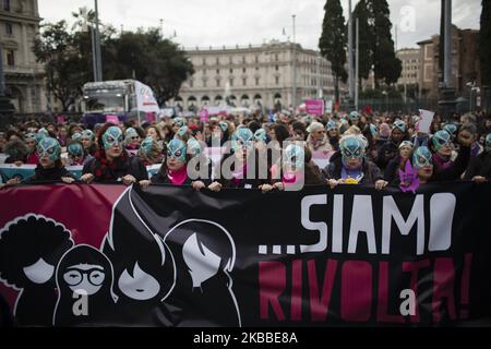 Women wear masks from the 'Lucha y Siesta' Women's Home project (Casa Delle Donne) for women victims of violence, during a protest march organized by the 'Non Una di Meno' (Not One Less !) movement in Rome, on November 23, 2019. Thousands of people took to the streets to denounce male violence against women, gender discrimination, and harassment in the workplaces. (Photo by Christian Minelli/NurPhoto) Stock Photo