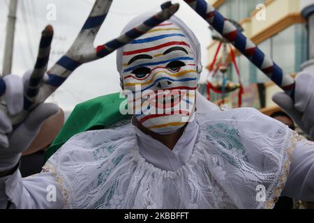 A performer dressed as the Clown walks the streets during the Mama Negra parade on November 23, 2019 in Latacunga, Ecuador. (Photo by RubÃ©n Espinosa/Agencia Press South/NurPhoto) Stock Photo
