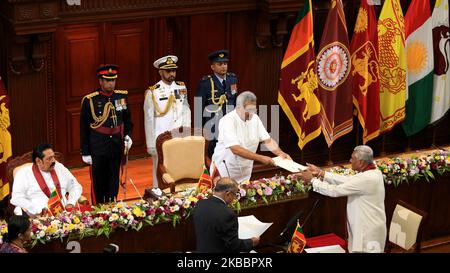 Sri Lanka's former speaker of the parliament and elder brother of the president, Chamal Rajapaksa (R) is appointed as the state minister of Defence as president Gotabaya Rajapaksa hands over official documents while their brother, prime minister Mahinda Rajapaksa (L) looks on during the ministerial swearing-in ceremony at the Presidential Secretariat in Colombo, Sri Lanka. Wednesday, 27 November 2019 (Photo by Tharaka Basnayaka/NurPhoto) Stock Photo