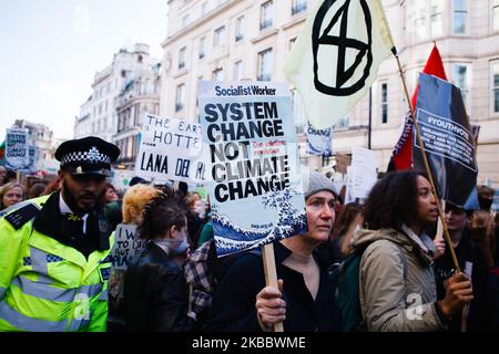 Activists march along Cockspur Street during the latest 'climate strike' demonstration in London, England, on November 29, 2019. Today's climate strike comes near the end of a year in which climate activism has taken centre stage in cities around the world, spearheaded both by the Greta Thunberg-inspired 'Fridays For Future' striker movement and by the activists of the equally-global Extinction Rebellion. Next week sees the two-week COP25 UN Climate Change Conference begin in Madrid. (Photo by David Cliff/NurPhoto) Stock Photo