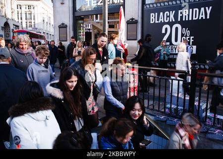 People pass a sign for Black Friday discounts outside Oxford Circus station in London, England, on November 29, 2019. (Photo by David Cliff/NurPhoto) Stock Photo