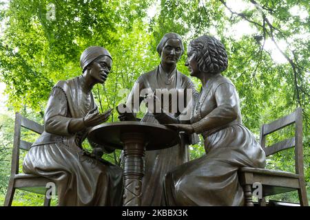 Women's Rights Pioneers Monument in Central Park, New York. Bronze sculpture of 3 women sitting on chairs and debating over women rights. Stock Photo