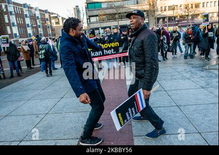 Two black men are dancing in front of the banners, during the Anti Black Piet rally in Eindhoven, on November 30th, 2019. (Photo by Romy Arroyo Fernandez/NurPhoto) Stock Photo