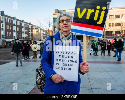 An old woman is holding two placards during the rally Anti Black Piet in Eindhoven, on November 30th, 2019. (Photo by Romy Arroyo Fernandez/NurPhoto) Stock Photo