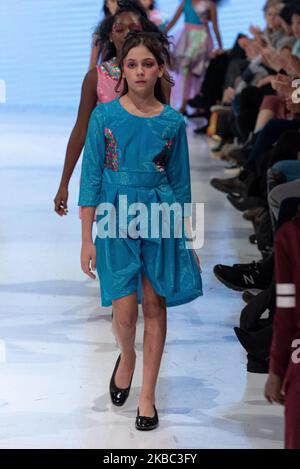 A model walks the runway at the Young Socialites collection for Spring and Summer 2020 during the third annual Toronto Kids Fashion Week fashion show on November 30, 2019 in Toronto, Canada (Photo by Anatoliy Cherkasov/NurPhoto) Stock Photo