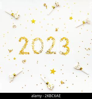 New 2023 Year golden star shaped confetti celebration background. Stock Photo