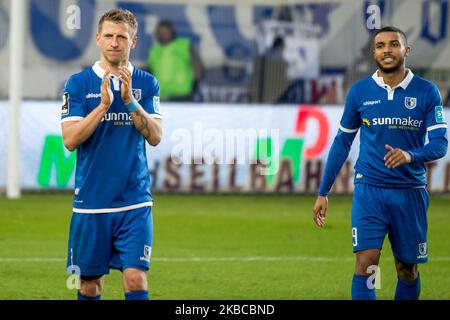 Dominik Ernst and Leon Bell Bell of 1. FC Magdeburg applauds at full time during the 3. Bundesliga match between 1. FC Magdeburg and FC Ingolstadt at the MDCC-Arena on December 07, 2019 in Magdeburg, Germany. (Photo by Peter Niedung/NurPhoto) Stock Photo