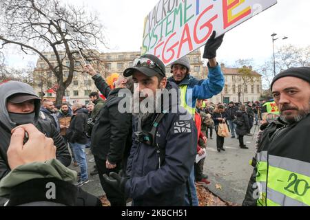 Jerome Rodrigues (C), one of the leading figures of the 'yellow vests' (gilets jaunes) movement, takes part in a demonstration on December 10, 2019 in Paris as part of the sixth day of a strike of public transport operators SNCF and RATP employees over French government's plan to overhaul the country's retirement system. Unions have vowed to keep up the fight over the reforms, which are set to be finalised and published on December 11. (Photo by Michel Stoupak/NurPhoto) Stock Photo