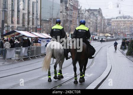 Mounted police patrol during Dutch farmers protest against government's agriculture policy in front of the Royal Palace at the Dam square on December 13, 2019 in Amsterdam,Netherlands. The representative of Agricultural and Horticultural Organisation (LTO) called for action and demanded a suspension of the nitrogen policy rules. (Photo by Paulo Amorim/NurPhoto) Stock Photo