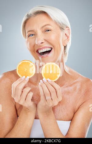 Fruit, orange and senior woman with a smile happy about skin beauty, wellness and healthy living. Portrait of elderly person with happiness about Stock Photo