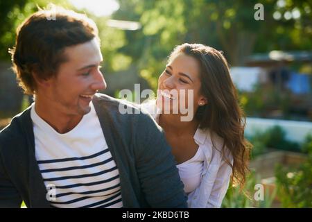 Being with you makes me the happiest. an affectionate young couple bonding outdoors. Stock Photo